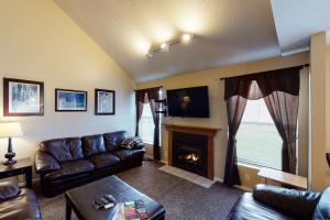 a living room with a couch and a fireplace at Skier's Four-Leaf Clover in Cottonwood Heights