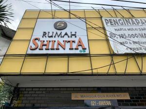 a sign on the side of a building at Hotel Rumah Shinta in Jakarta