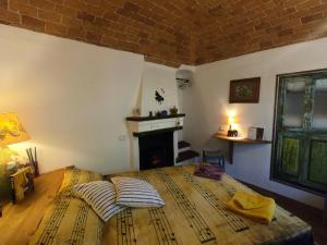 a bedroom with a bed with two pillows and a fireplace at Bed and breakfast Ca du 5 in Tovo San Giacomo