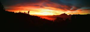 a sunset in the mountains with the sun setting at Hotel San Remo in San Zeno di Montagna