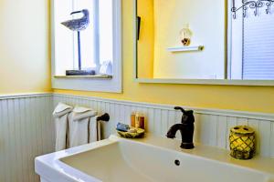 a white sink in a bathroom with a mirror at Villa Venezia in Fort Lauderdale +42 photos