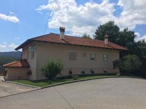 a large house with a driveway in front of it at Rooms Šajina in Podgrad