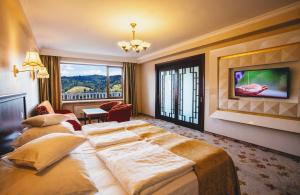 a hotel room with a large bed and a large window at Hotel Gołębiewski Wisła in Wisła