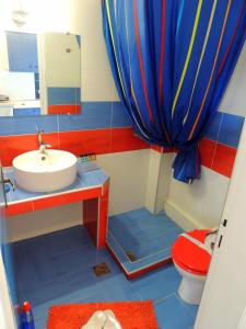 a bathroom with a sink and a toilet and a shower curtain at Kalamitsi Studios in Kalamitsi