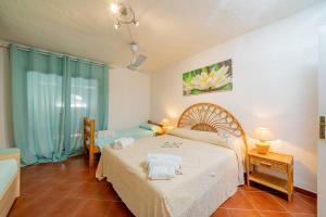 a bedroom with a bed with towels on it at Casa Leda in Golfo Aranci