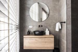 a bathroom with a sink and a mirror at Ysbrantsz Boutique Hotel in Hoorn