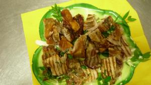 a green plate of food with meat and gravy at Agriturismo Isidoro in Fertilia