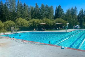 a large swimming pool with people in the water at Elkhorn Studio Condo - The Clocktower in Sun Valley