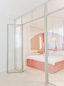 a bedroom with a canopy bed with glass doors at Jupiter Silesian Place Apartments in Katowice