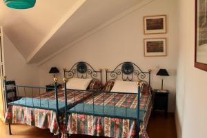 a bedroom with a bed with a metal frame at Casa do Balcão in Alcains
