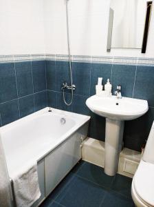 a bathroom with a sink and a tub and a toilet at Inn Rio in Astrakhan