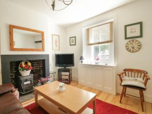 a living room with a couch and a fireplace at All Saints View in Cockermouth