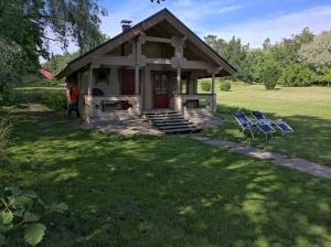 a small house with two blue chairs in the yard at Päiväkulma in Naantali