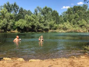 a man and a woman swimming in a river at "Pivnica i smestaj Jovanovic"- Rogljevacke pivnice in Rogljevo