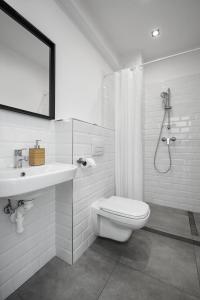 a bathroom with a toilet and a sink and a shower at Hotel Chesscom in Budapest