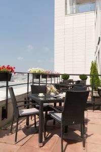 a patio with a table and chairs on a balcony at Апартамены Азбука на Гостином Дворе с террасой in Ufa