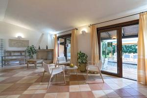 a living room with a table and chairs at Porto Giunco Residence in Villasimius