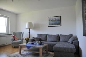 a living room with a couch and a table at Rothaarsteig Ferienhaus in Kirchhundem