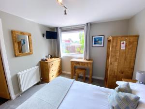 Postel nebo postele na pokoji v ubytování Cairngorm Guest House
