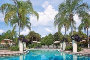 a beach with palm trees and palm trees at CLC Encantada Resort Vacation Townhomes in Kissimmee