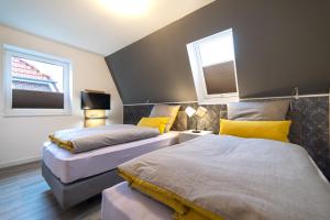 Un pat sau paturi într-o cameră la Ferienhaus Muschelpadd 3d