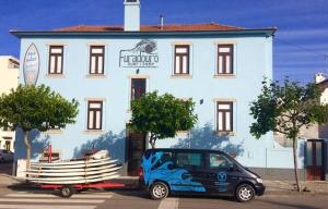 a small car parked in front of a building at Furadouro Surf Camp (Studios) in Ovar