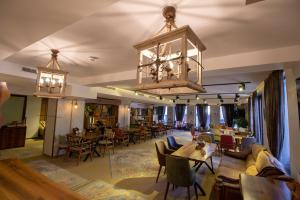 um restaurante com mesas e cadeiras e um lustre em Wellness Hotel Bulgaria em Bansko