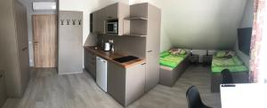 a small room with a kitchen and a bed at Apartmány U Stadionu in Šumperk