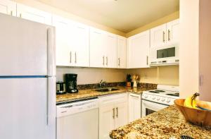 a kitchen with white cabinets and a counter top at Villa Venezia in Fort Lauderdale