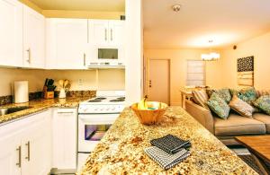 a kitchen with a counter top and a living room at Villa Venezia in Fort Lauderdale