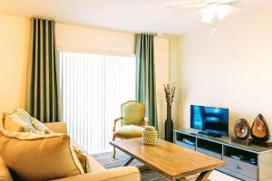a living room with a couch and a tv at Villa Venezia in Fort Lauderdale