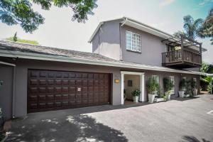 a house with a garage and a balcony at Westville Bed and Breakfast in Durban