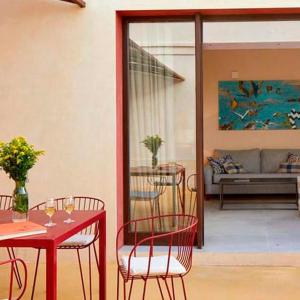 a patio with a table and chairs and a couch at Trafalgar Polo Club in El Palmar