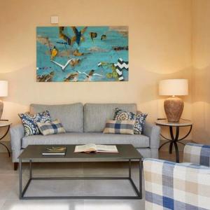 a living room with a couch and a table at Trafalgar Polo Club in El Palmar
