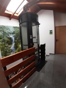 a phone booth in a room with a waterfall painting on the wall at Hostal la Catedral in Santo Domingo de la Calzada