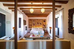 イビサ・タウンにあるHotel La Torre del Canonigo - Small Luxury Hotelsのベッドとテーブルが備わるホテルルームです。