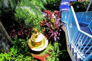 a yellow fire hydrant in a garden with plants at Villa Venezia in Fort Lauderdale