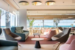 a lobby with couches and chairs and a table at Les Dunes Comodoro in Benidorm