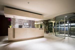 a lobby with a reception desk in a building at Les Dunes Comodoro in Benidorm +37 photos
