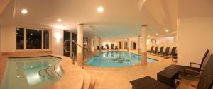 a large swimming pool in a building at Hotel Grones in Ortisei