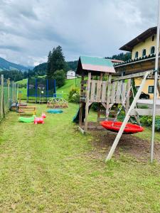 a playground with several swings and a play structure at Appartements Samerhof - TOP 1 in Kaltenbach