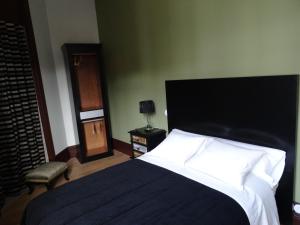 a bedroom with a bed with a black and white comforter at GuestReady - Belle Epoque Apartmento - 3.1 in Porto
