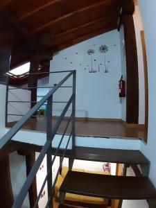 a staircase in a house with a sign on the wall at Vivienda Turistica La Catedral in Santo Domingo de la Calzada