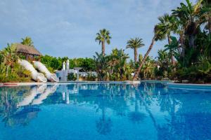 a pool at a resort with a water slide at Alannia Guardamar in Guardamar del Segura