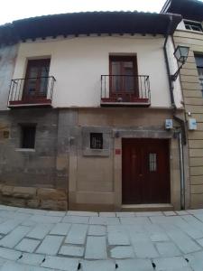 a house with two balconies on the side of it at Vivienda Turistica La Catedral in Santo Domingo de la Calzada