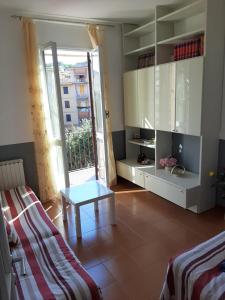 a room with a bed and a table and a window at La Dimora di Nadine in La Spezia