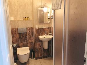 a bathroom with a toilet and a sink at Dove Apart Hotel in Fethiye