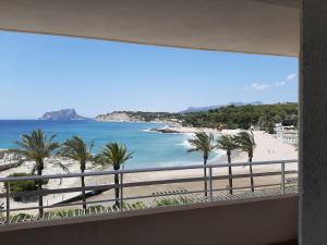 a view of the beach from a balcony at Moraira Beach in Moraira