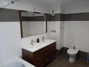 a bathroom with a sink and a toilet and a mirror at Moraira Beach in Moraira