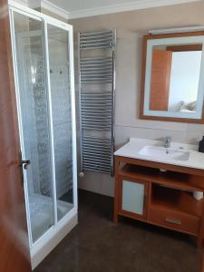 a bathroom with a glass shower and a sink at Moraira Beach in Moraira